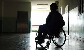 Silhouette of lady in a wheelchair