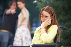 2 girls talking behind another's back